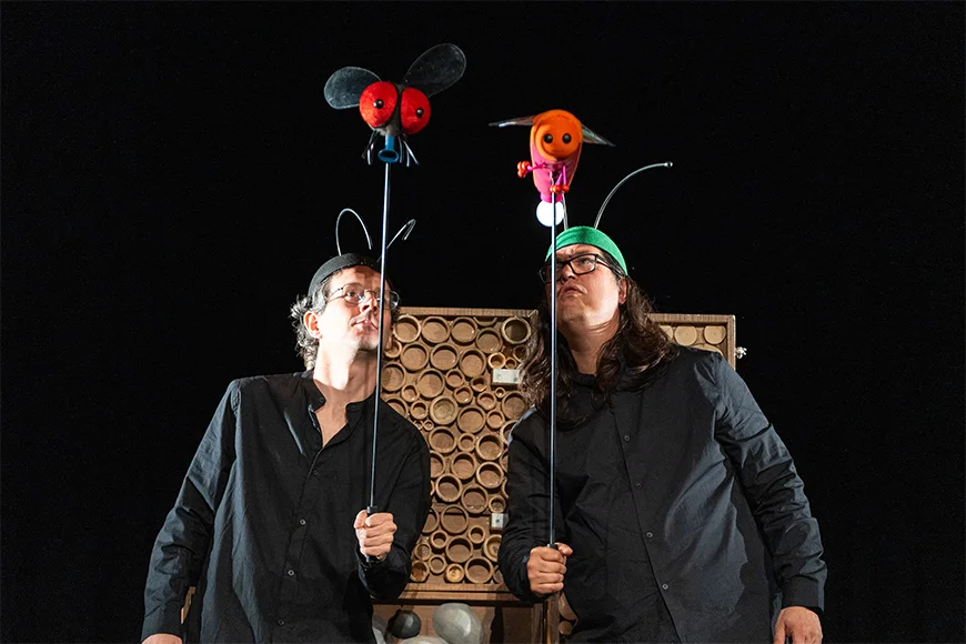 Dos actors sostenen dos titelles d'insectes